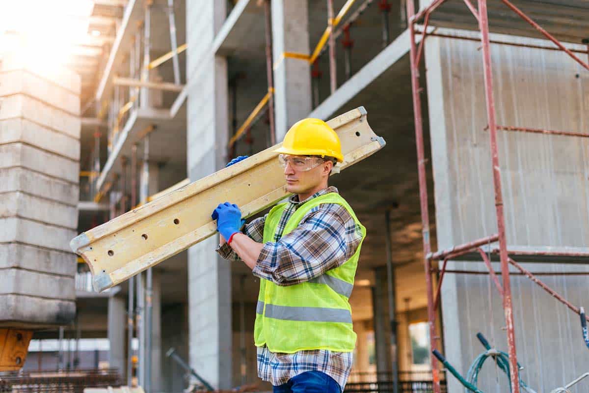 Image of construction worker on construction site, working on site where skyscraper is being built. Manual worker has protective helmet and protective uniform. Image taken with Nikon D800 and professional Nikon lens, developed from RAW in highest resolution. Location: Novi Sad, Serbia, Europe