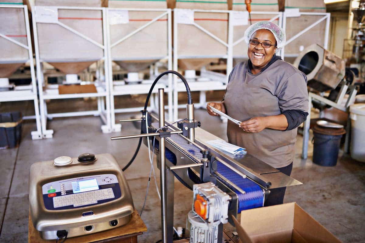 Portrait of a smiling woman at work in a distribution warehouse